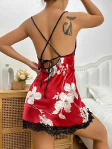 Detail showing the backless design with cross straps and lace trim on a red satin floral nightie
