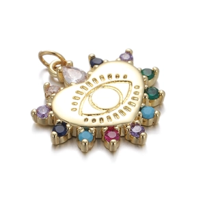 Macro shot of gold heart pendant featuring a multi-colored stone evil eye design