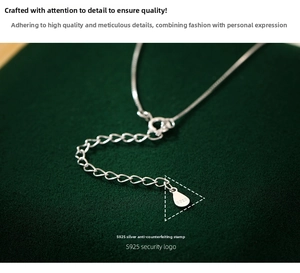 Detail of S925 sterling silver extender chain and hallmark on green velvet
