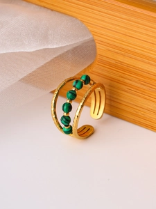 Detail view of gold double-layer hammered ring with six green malachite beads