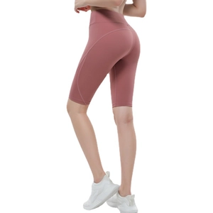 Women's high-waisted yoga shorts in dusty rose featuring ergonomic curved stitching