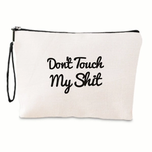Detail of off-white canvas makeup bag with Don't Touch My Shit print and black zipper