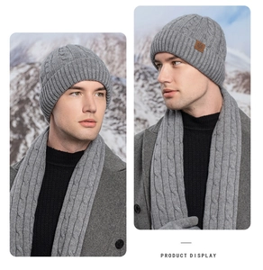 Detail showing the gray knitted winter beanie and matching cable knit scarf set for men