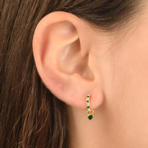Elegant gold hoop earrings with green heart-shaped gemstones and sparkling zircons