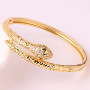 Golden snake-shaped bangle with white pavé zircons and green gemstone eyes for women