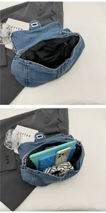 Detail of blue denim tote bag with chain strap showing spacious interior for tablets