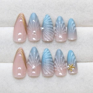 Blue gradient almond press-on nails with 3D shell texture, pearls and golden accents