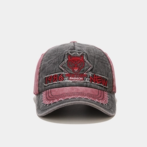 Close-up of vintage washed baseball cap with husky embroidery and retro patchwork design