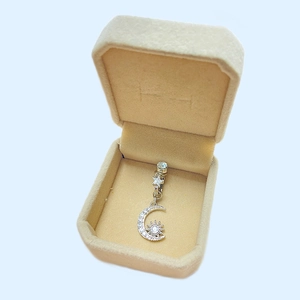 Star and moon silver belly ring with crystals in a beige velvet jewelry gift box
