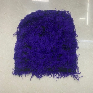 Detail view of purple knitted beanie featuring soft fuzzy texture and distressed fringe style