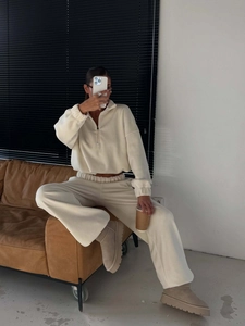 Women's cream fleece lounge set featuring half-zip long sleeve top and wide-leg pants
