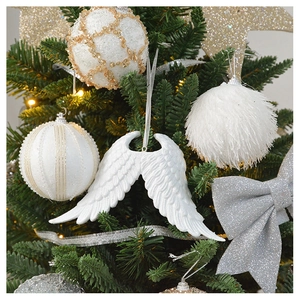 Detail of white plush foam balls and silver sequin star ornaments on a Christmas tree