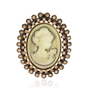 Detail view of vintage cameo brooch with oval figure silhouette and crystal accents