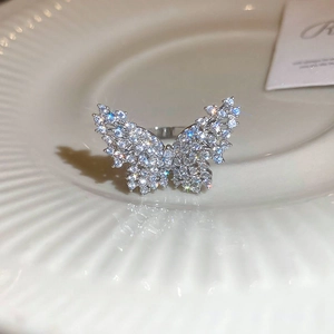 Macro shot of a butterfly ring with silver plating and sparkling pavé zircon stones