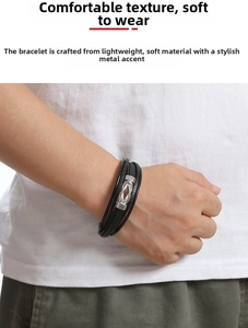 Close-up of multilayer woven black leather bracelet with silver metal buckle on male wrist