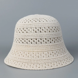 Close-up of cream crochet bucket hat showing hollow knit texture and breathable pattern