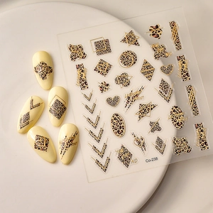 Leopard print nail stickers with gold geometric heart and star patterns on cream base