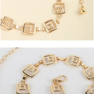 Detail of gold geometric double square link chain belt with lobster clasp and ball charm