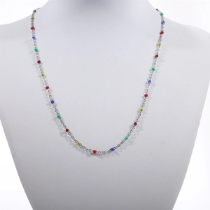 Detail of colorful beads on a silver stainless steel necklace shown on a display stand