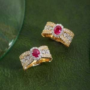 Detailed macro view of vintage gold rings with oval red gemstone and lace metalwork