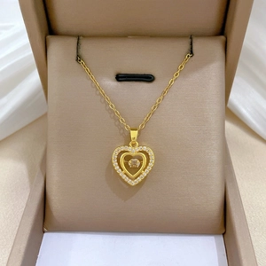 Detailed view of heart necklace with sparkling crystals and gold finish on satin fabric