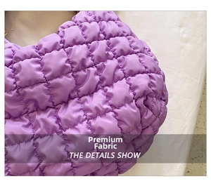Detail of lavender quilted fabric showing smooth glossy finish and puffy grid stitching