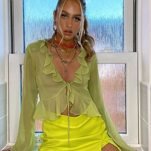 Detail of lime green sheer ruffled top with long sleeves and front tie closure