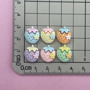 Mini resin strawberry charms with flower detail in assorted pastel colors for DIY crafts
