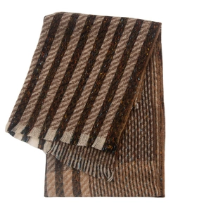 Detail of wool blend striped scarf with brown herringbone pattern and fringe edges