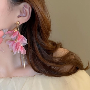Detail of pink floral tassel earrings with long gold chain and sheer mesh petals
