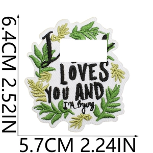 Close-up of embroidered patch with LOVES YOU text and leaf detail including size markings