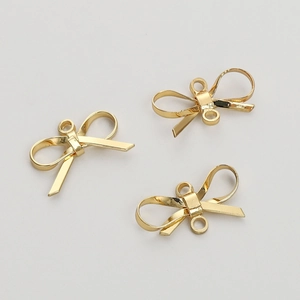 Detailed view of three 14K gold-filled 3D bow-knot charms for DIY jewelry making