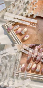 Detail of M-983 nail stickers featuring white bows and lace on cat-eye fake nails