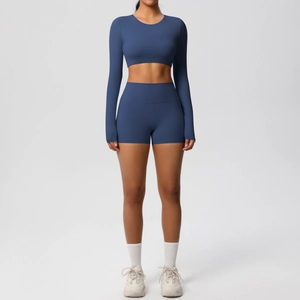 Detail of navy blue high-stretch yoga set with long sleeve crop top and biker shorts