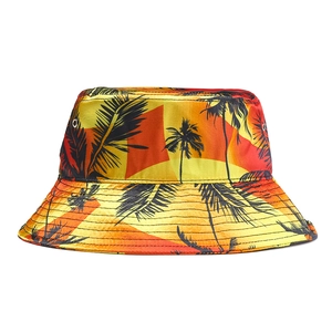 Detail of satin bucket hat with tropical sunset print and metal eyelets for ventilation