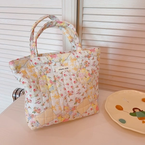 Quilted floral cotton handbag with Simple Wish label on bright home background