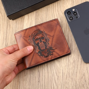 Brown vintage men's short leather wallet featuring embossed skull pattern on wooden table