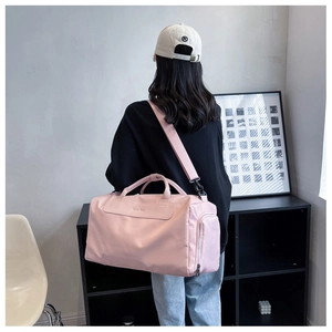 Pink large capacity travel bag for gym and yoga shown in a lifestyle model back view