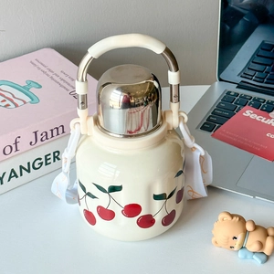 Close-up of cream stainless steel bottle with cherry print and adjustable strap
