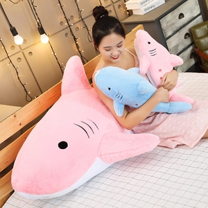 Detail of plush shark toy showing soft blue fabric texture and stitched gill features