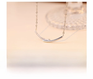 Detail view of titanium steel smile necklace with cubic zirconia inlay and silver plating