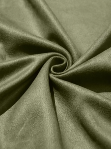 Macro shot of olive green suede fabric showing soft texture and premium pleated drape