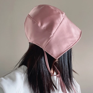 Vintage pink satin sun hat with lace-up ribbons for retro photography and summer travel