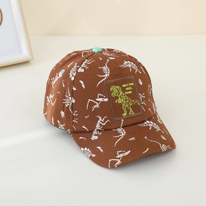 Detail of kids brown baseball cap featuring green dinosaur embroidery and bone prints