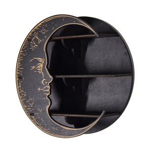 Detail view of black wooden moon-shaped shelf with mystic face carving and triple tiers