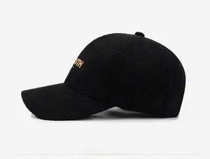 Side view of black baseball cap with yellow Youth embroidery and needlework texture