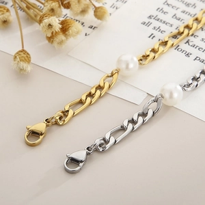 Detail of gold and silver Figaro chains with large pearls and secure lobster clasps