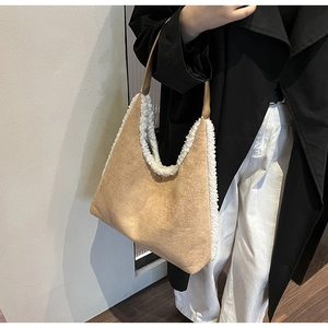 Detail of camel suede tote bag with white plush trim and magnetic closure handle