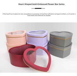 Detail view of heart-shaped gift boxes with clear windows and golden Rose lettering
