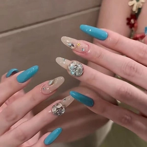 Luxury long almond press-on nails with peacock blue finish and sparkling crystal rhinestones